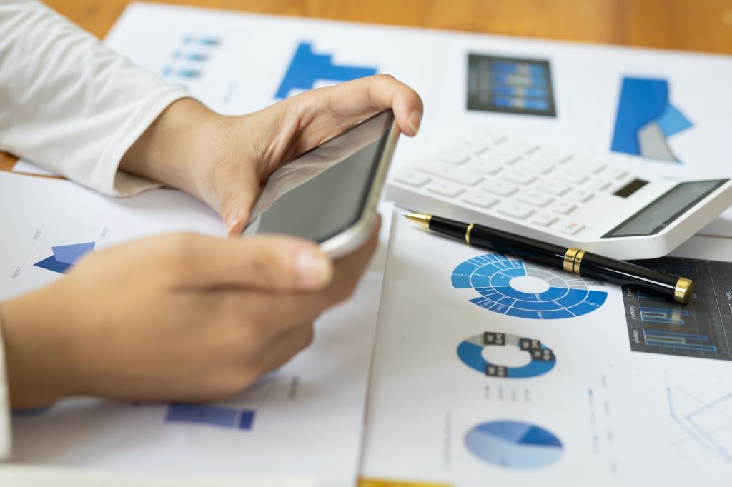 Woman checking invoices and financial bills on modern smartphone.